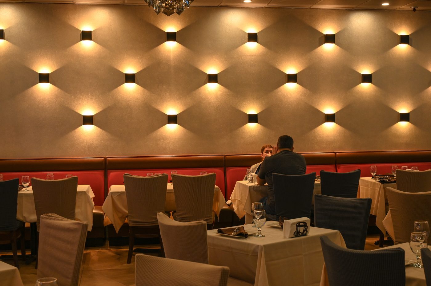 Warm sconce-lit dining wall