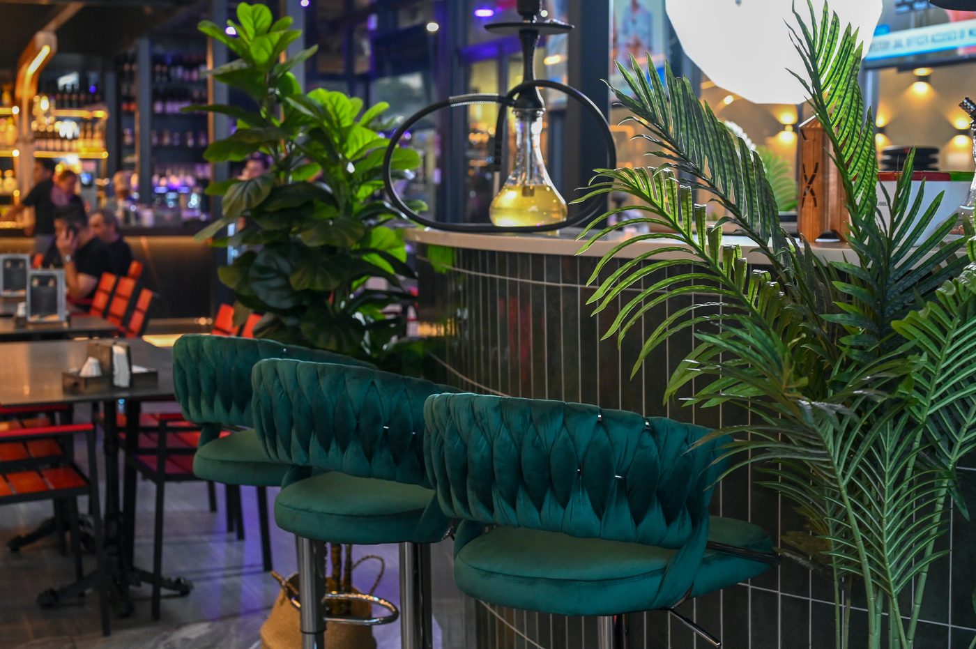 Teal velvet stools at the lounge bar